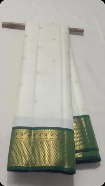 White pure silk Kancheepuram saree with a woven green and gold zari temple border.